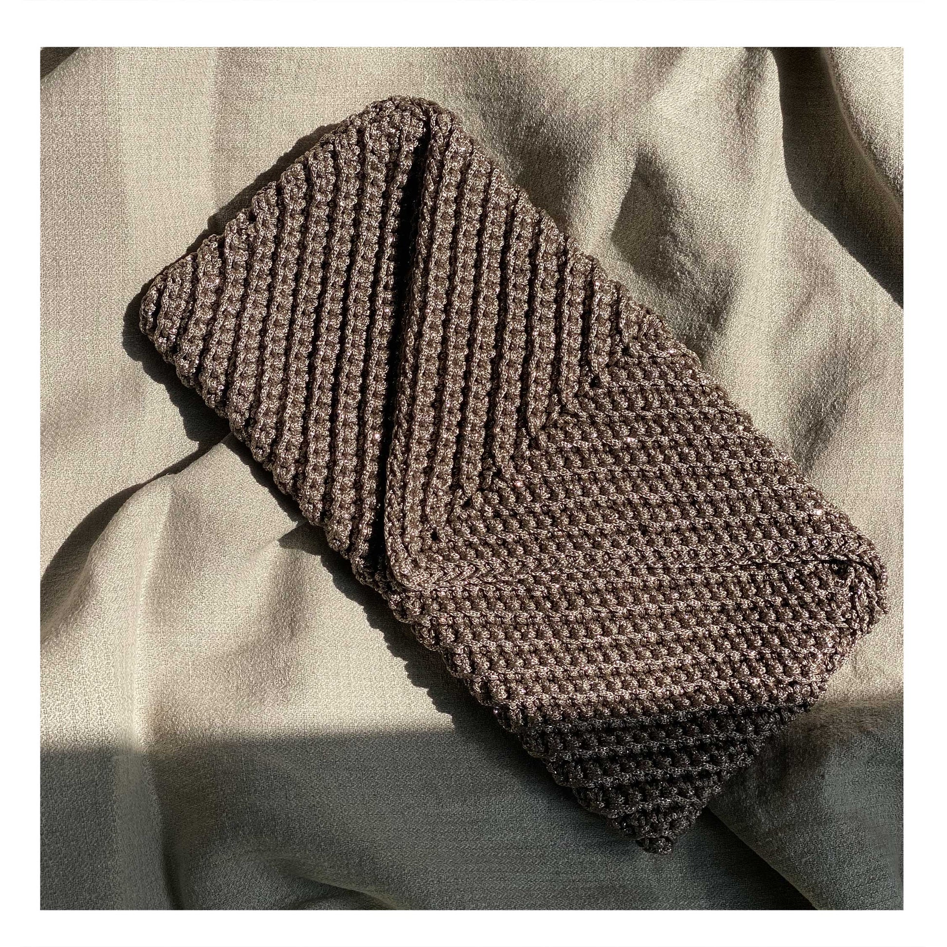 Handmade crochet bag in vibrant colors,  showcasing intricate craftsmanship inspired  by Lebanese artistry. A unique and sustainable  accessory from Dhalu World, adding a touch of  warmth and cultural richness to your style
