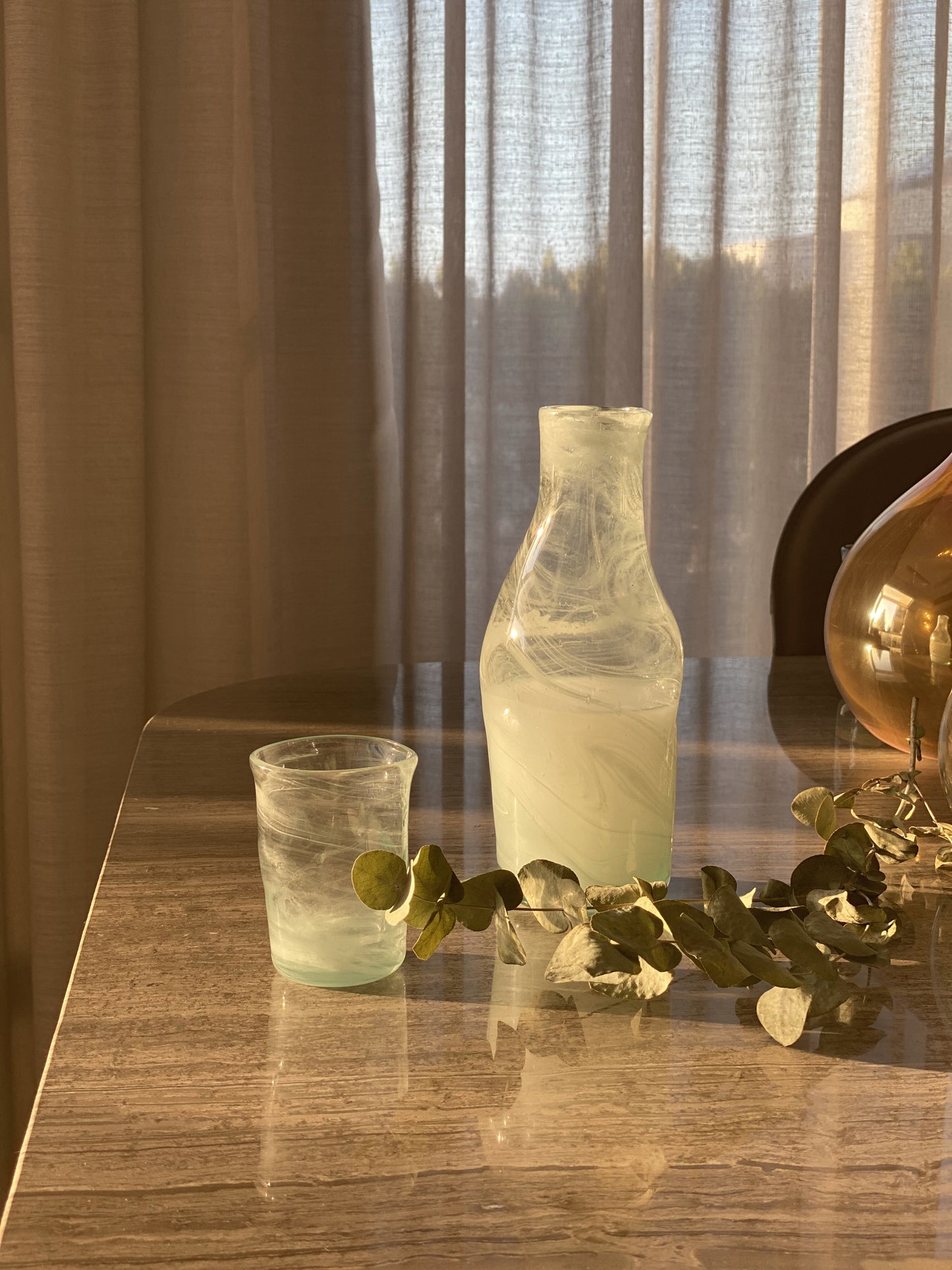 Elevate your sipping experience with our Deformed White Arak Mini Cups, exquisite blown glass creations proudly crafted in Lebanon. Each mini cup is a vibrant swirl of white bringing joy and charm to your table.
