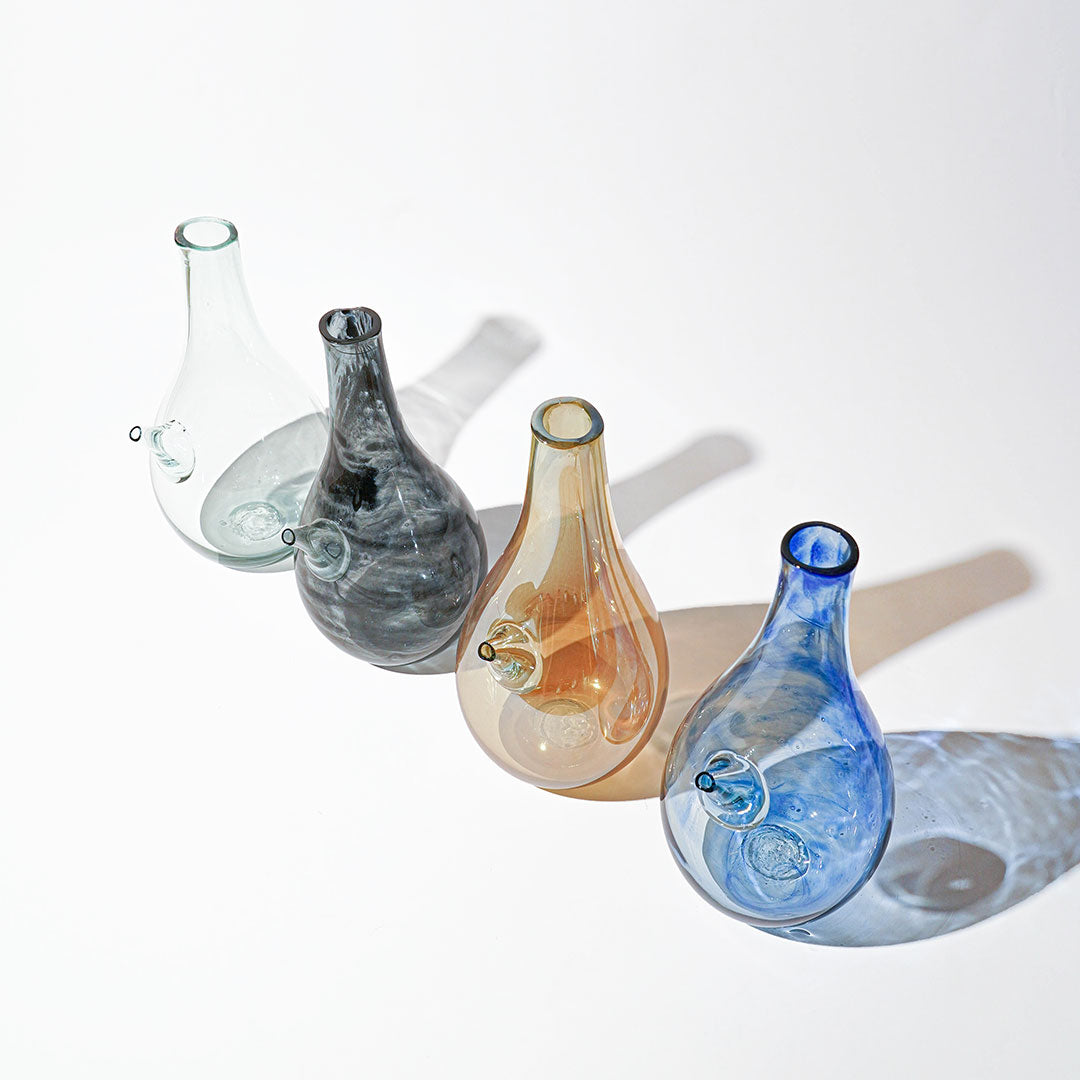 Introducing the Ibrik Recycled Glass Vase and functional liquid Jug – a versatile and eco-friendly piece that seamlessly merges functionality with aesthetic appeal. Crafted with care from recycled glass, the Ibrik is not only a sustainable choice but also a testament to the beauty of repurposed materials.