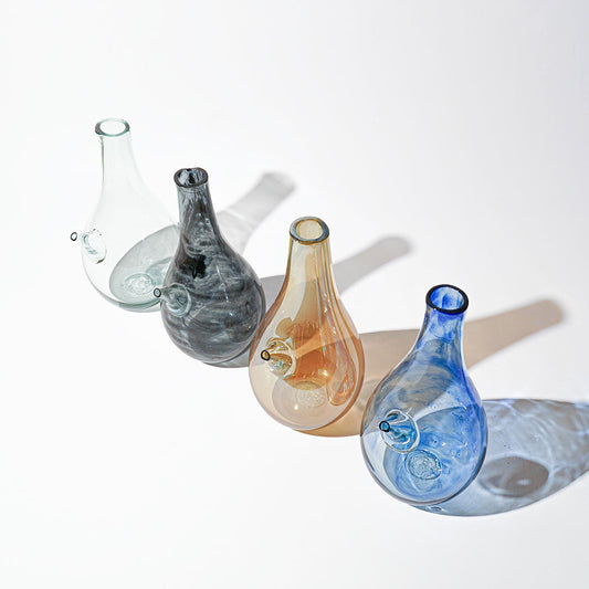 Introducing the Ibrik Recycled Glass Vase and functional liquid Jug – a versatile and eco-friendly piece that seamlessly merges functionality with aesthetic appeal. Crafted with care from recycled glass, the Ibrik is not only a sustainable choice but also a testament to the beauty of repurposed materials.