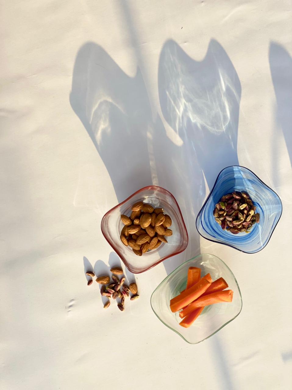 Dive into a world of vivid hues and environmentally-friendly living with this stunning snack bowl ensemble. The recycled glass not only adds a unique texture but also tells a tale of repurposing, making each piece a work of art.