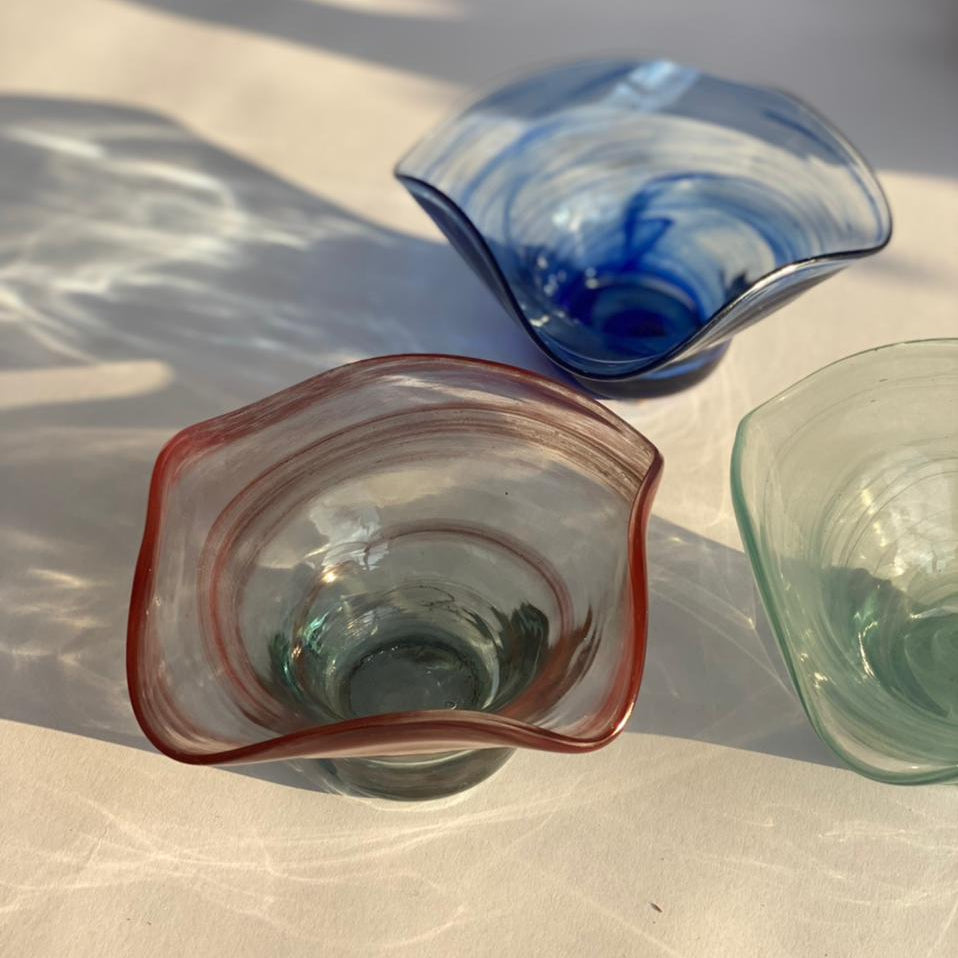 Dive into a world of vivid hues and environmentally-friendly living with this stunning snack bowl ensemble. The recycled glass not only adds a unique texture but also tells a tale of repurposing, making each piece a work of art.